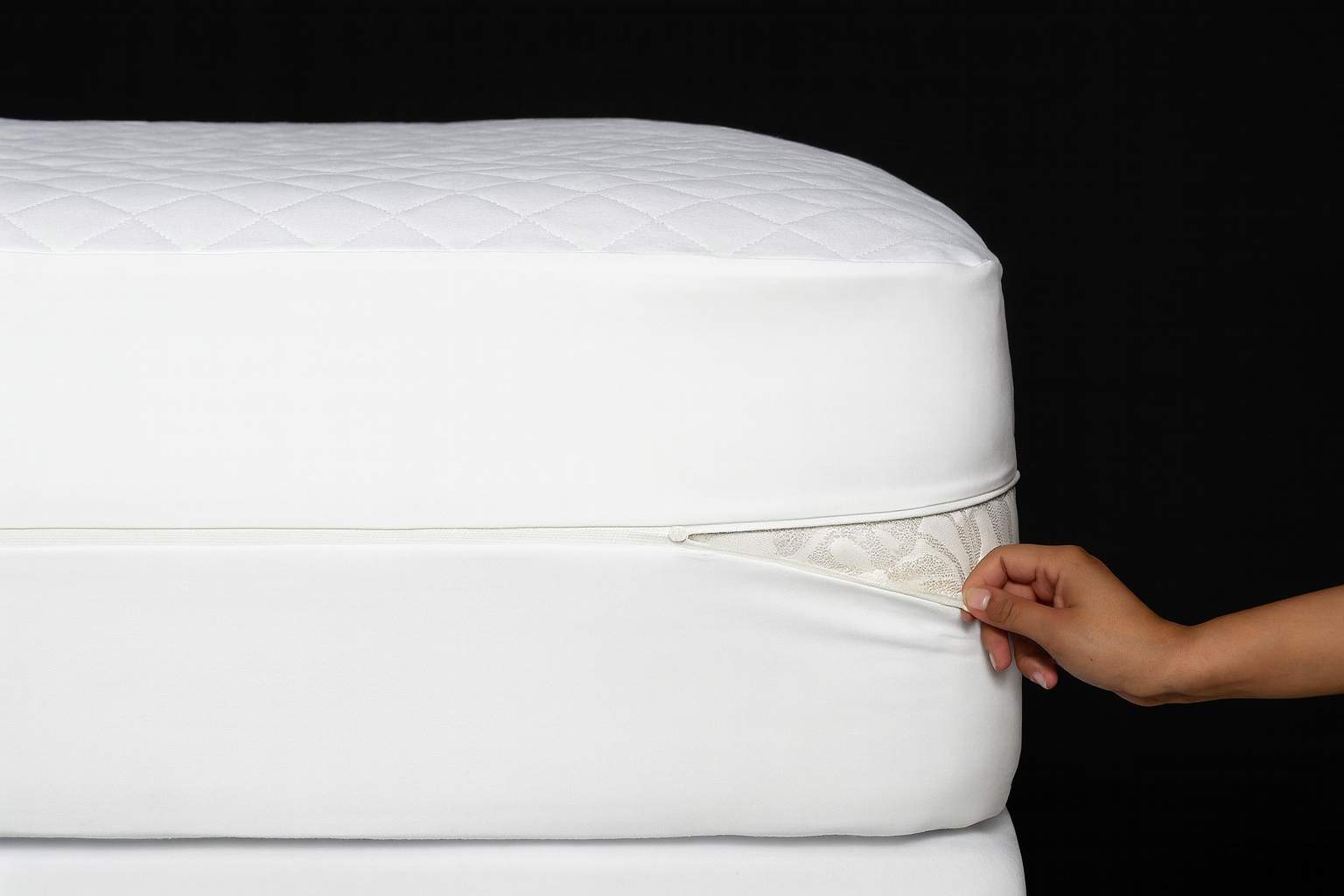 Bedbug-proof mattress encasement being zipped around a mattress for hotel and healthcare protection